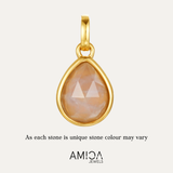 Gold pendant with a teardrop-shaped stone on a light beige background, featuring the AMICA Jewels brand.