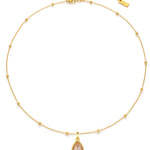 Gold necklace with a teardrop-shaped pendant on a white background