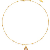Gold necklace with a teardrop-shaped pendant on a white background