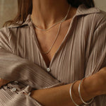 a silver cuff bracelet with a round shape. The bracelet is made entirely of silver, with a smooth and polished finish. This versatile silver cuff bracelet adds a touch of elegance and sophistication to any wrist.