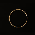 a 18k gold vermeil cuff bracelet with a round shape. The bracelet is made entirely of silver, with a smooth and polished finish. This versatile 18k gold vermeil cuff bracelet adds a touch of elegance and sophistication to any wrist.