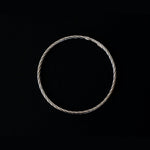 a silver twisted round bracelet with a round shape. The bracelet is made entirely of silver, with a smooth and polished finish. This versatile silver cuff bracelet adds a touch of elegance and sophistication to any wrist.